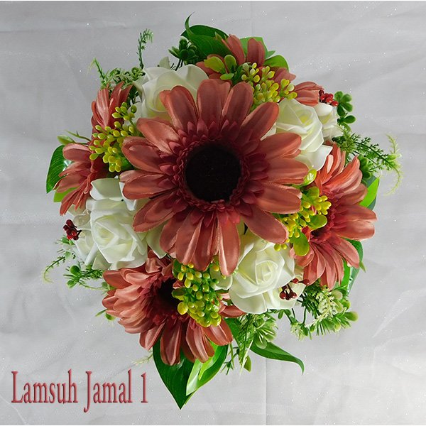 Artificial flower arrangement with rust gerbera daisies and white roses in white pot