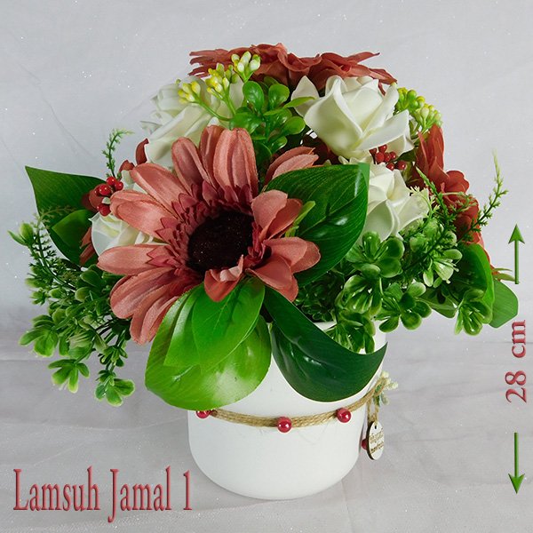 Artificial flower arrangement with rust gerbera daisies and white roses in white pot