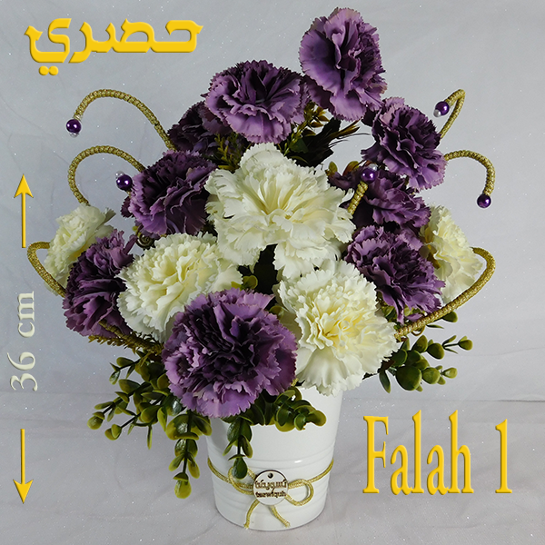 Filleh bouquet in white ceramic vase with varied imported blooms and meaningful color palette