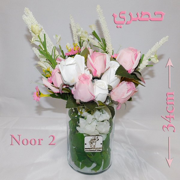 Glass vase flower arrangement with pink roses, white roses, and gerberas in clear glass vase