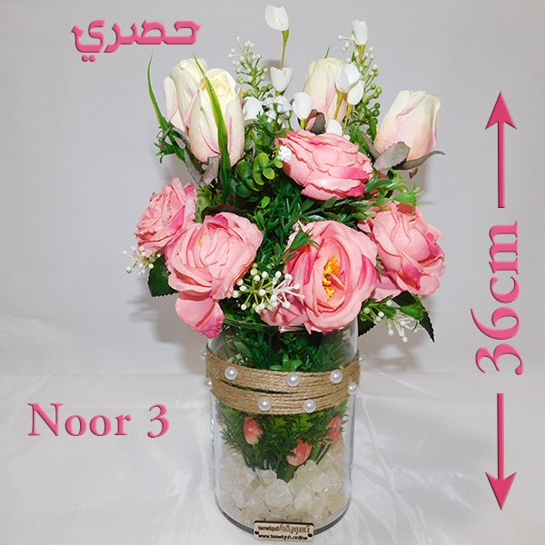 Glass vase flower arrangement with pink roses, white roses, and gerberas in clear glass vase