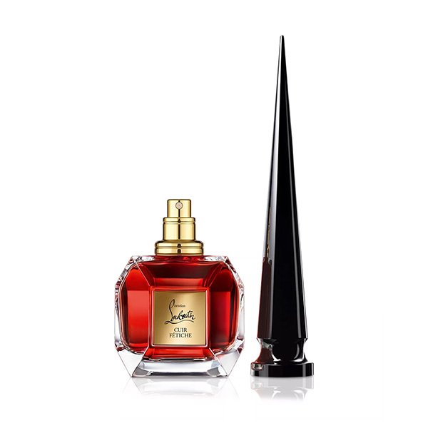 Leather Perfume Cuir Fétiche flacon with gold spray and sculptural black cap beside