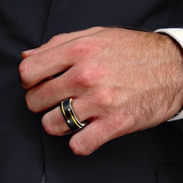 Mens Wedding Ring Italo black gold tungsten-style worn on man's hand over dark suit