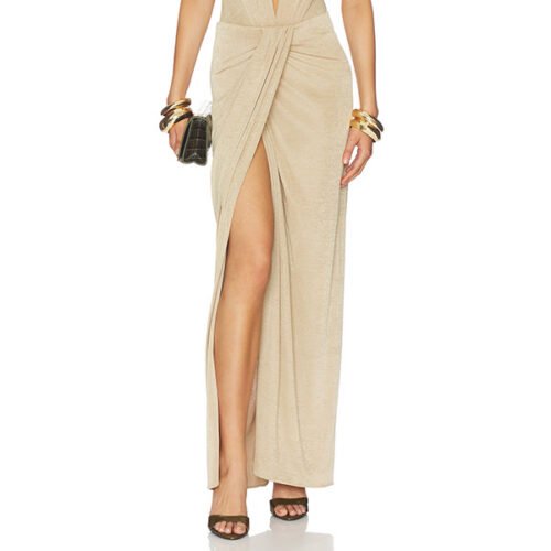 "The Andamane Anja draped maxi skirt in gold midweight velvet with faux wrap styling, elastic waistband and side slit detail"