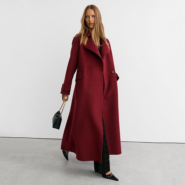 Red Coat REISS Alara walking view showing 56 inch hem sweep and black chain bag