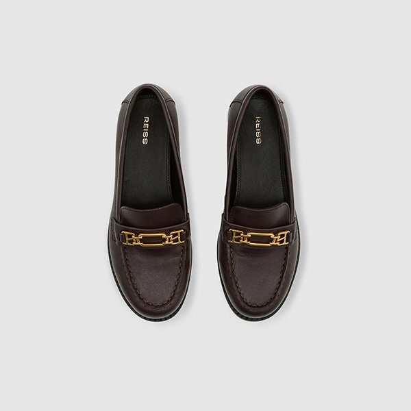 Top-down view of REISS Rita Chocolate Loafers displaying gold-tone hardware and stitched apron toe