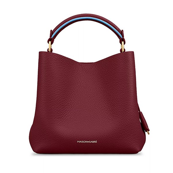 Plum Sky mini bucket bag showing burgundy leather with blue contrast handle and gold hardware